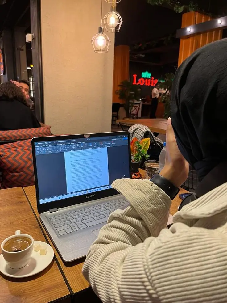 A Girl working as a digital marketing specialist in kannur, analyzing social media and SEO data on her laptop.